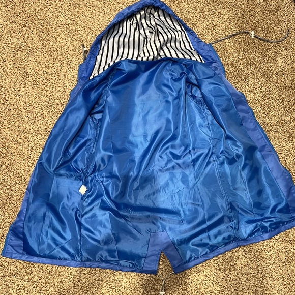 Rain jacket - blue.  Never worn.  Size M runs SMALL.  Drawstring waist and hood - Picture 3 of 7